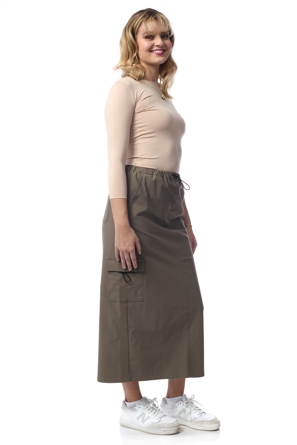 woman wearing fatigue khaki army green colored midi length cargo skirt with pockets 